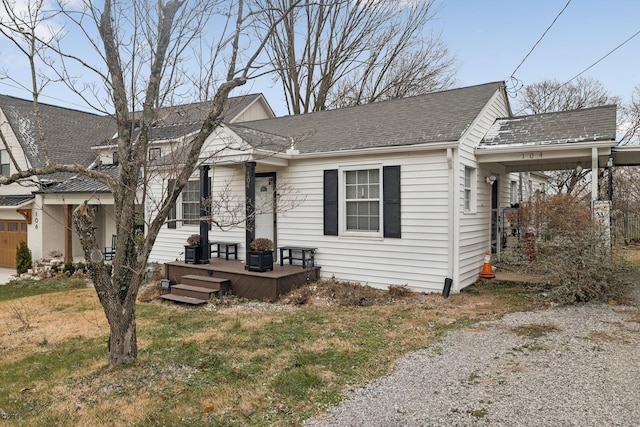 bungalow featuring a front lawn and a deck