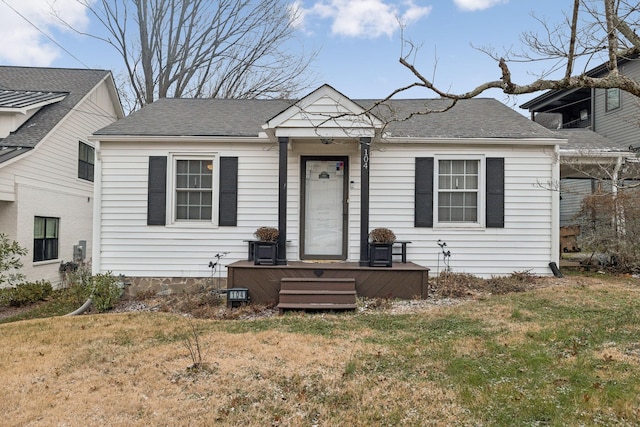 view of front facade with a front yard and a wooden deck