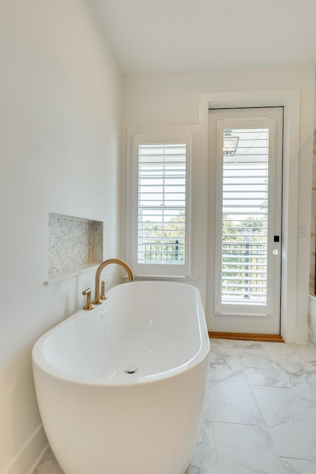 bathroom with a tub to relax in