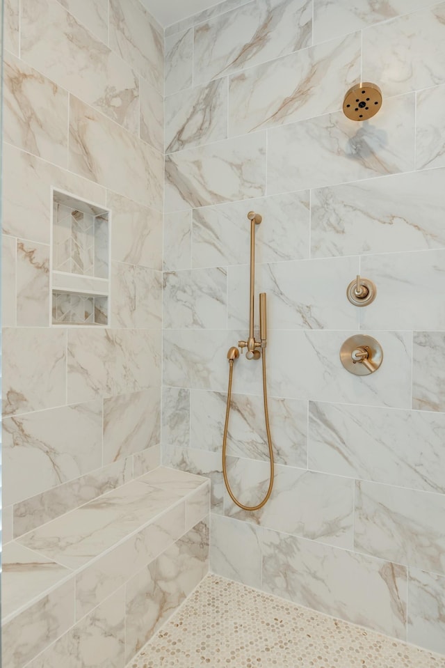 bathroom with a tile shower