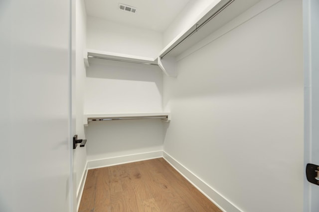 spacious closet with hardwood / wood-style flooring