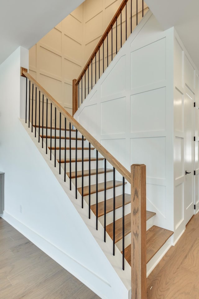 staircase with hardwood / wood-style floors