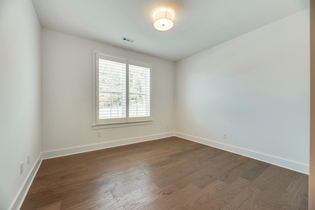 spare room with dark hardwood / wood-style flooring