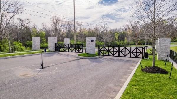 view of gate with a lawn