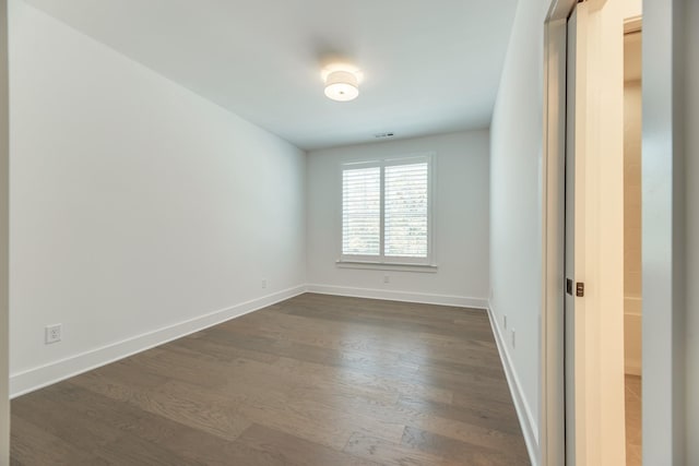 empty room with dark wood-type flooring