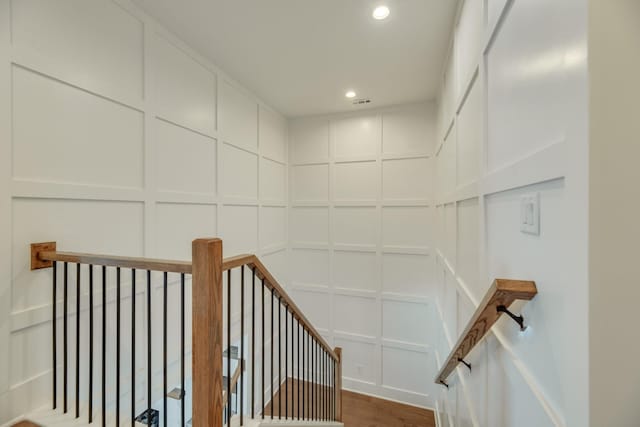 stairway featuring wood-type flooring