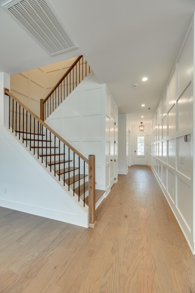 corridor with light hardwood / wood-style floors