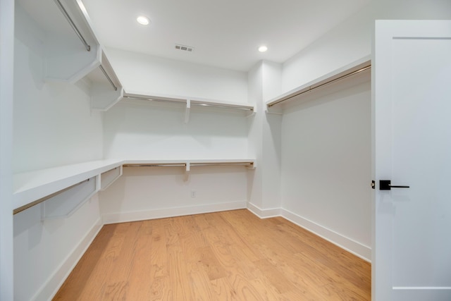 spacious closet featuring light hardwood / wood-style flooring