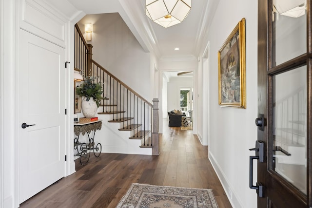 entryway with dark wood-type flooring and crown molding