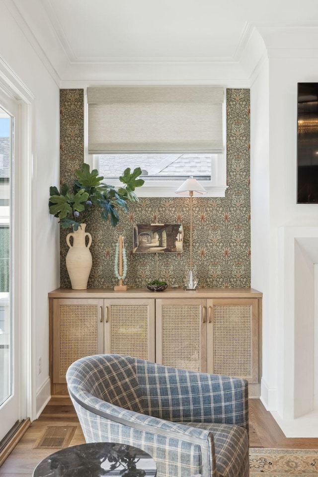 bar featuring wood-type flooring, a wealth of natural light, and ornamental molding