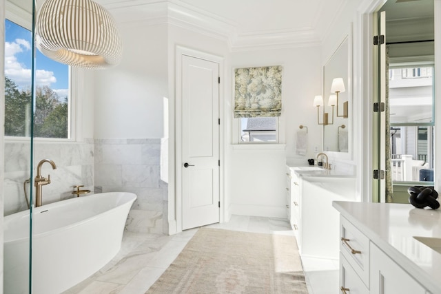 bathroom with a bath, crown molding, tile walls, and vanity