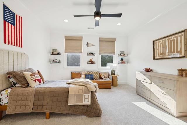 carpeted bedroom featuring ceiling fan and ornamental molding