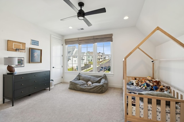 carpeted bedroom with ceiling fan and vaulted ceiling