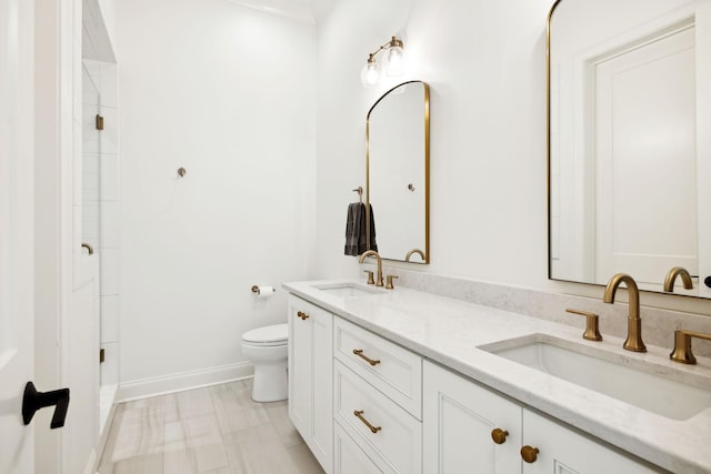 bathroom featuring toilet and vanity