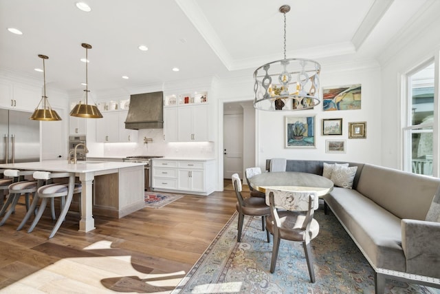 dining area featuring dark hardwood / wood-style flooring, sink, a chandelier, and breakfast area