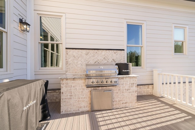 wooden terrace featuring a grill and area for grilling