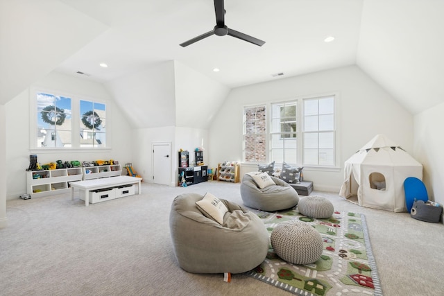 interior space featuring ceiling fan, vaulted ceiling, and carpet floors