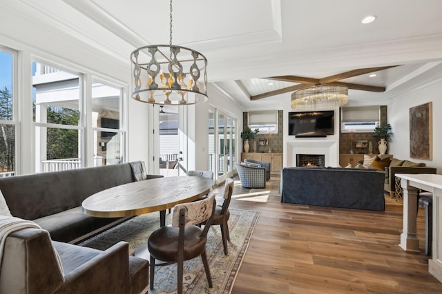 dining room featuring beam ceiling, hardwood / wood-style floors, crown molding, and an inviting chandelier