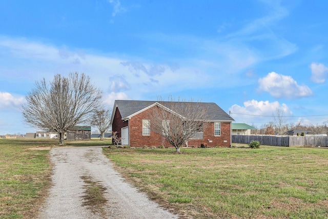 view of side of home featuring a lawn and a garage