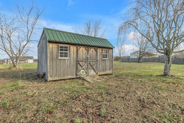 view of outbuilding with a yard