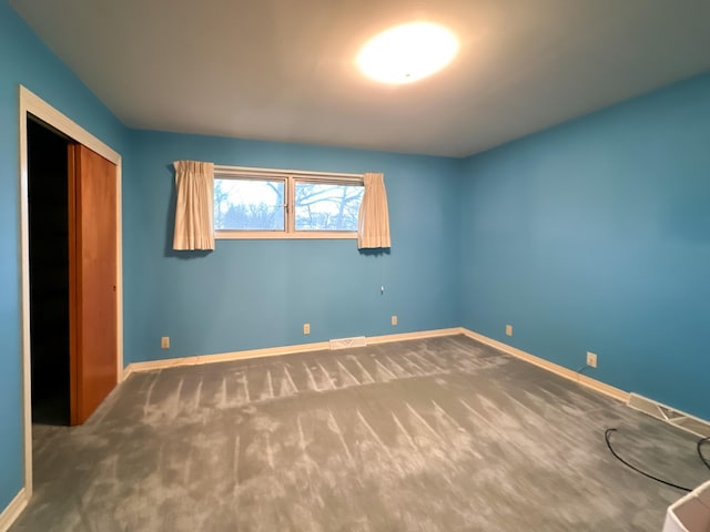 unfurnished bedroom with carpet floors and a closet