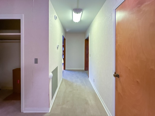 hallway with light colored carpet