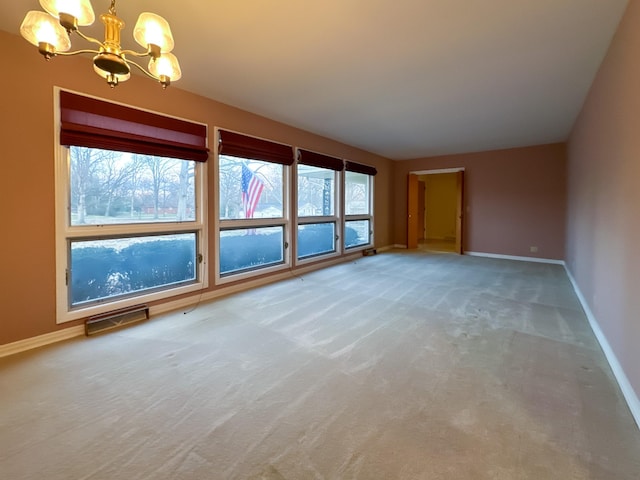 unfurnished living room with carpet and a chandelier