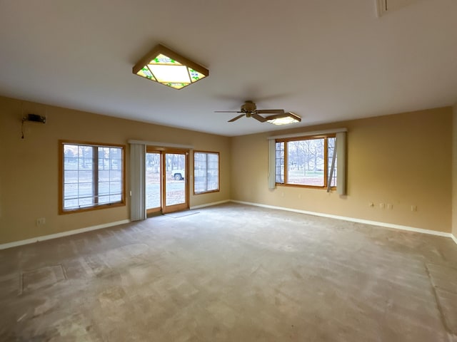 empty room featuring ceiling fan and carpet flooring