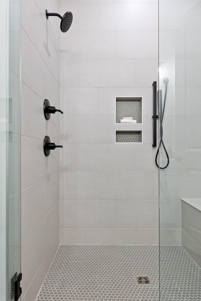 bathroom with a shower with door