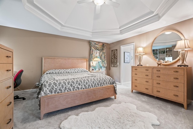 carpeted bedroom featuring a raised ceiling, ceiling fan, and ornamental molding