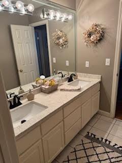 bathroom featuring tile patterned flooring and vanity