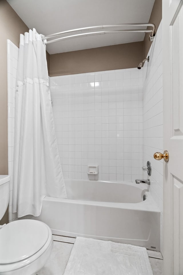 bathroom with tile patterned floors, shower / bath combination with curtain, and toilet