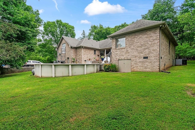 rear view of house featuring a lawn