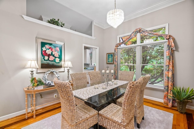 dining space with a notable chandelier, light wood-type flooring, and a wealth of natural light