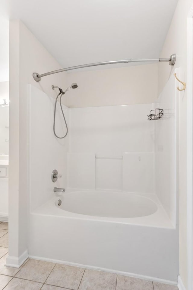 bathroom with tile patterned floors and shower / bath combination