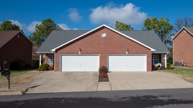 view of front of property featuring central AC unit and a garage