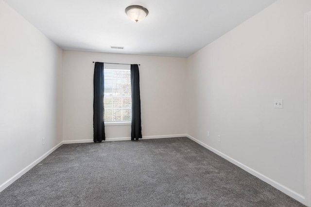 empty room featuring dark carpet