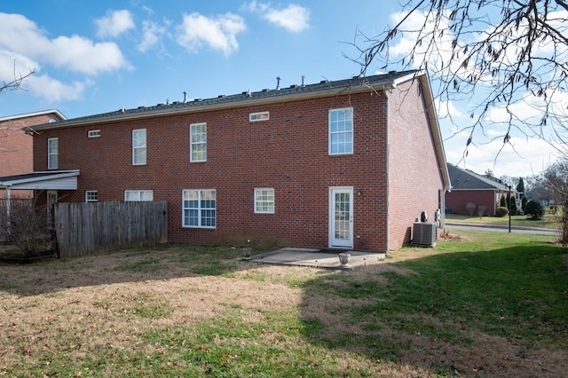 rear view of house featuring a yard, central AC, and a patio area