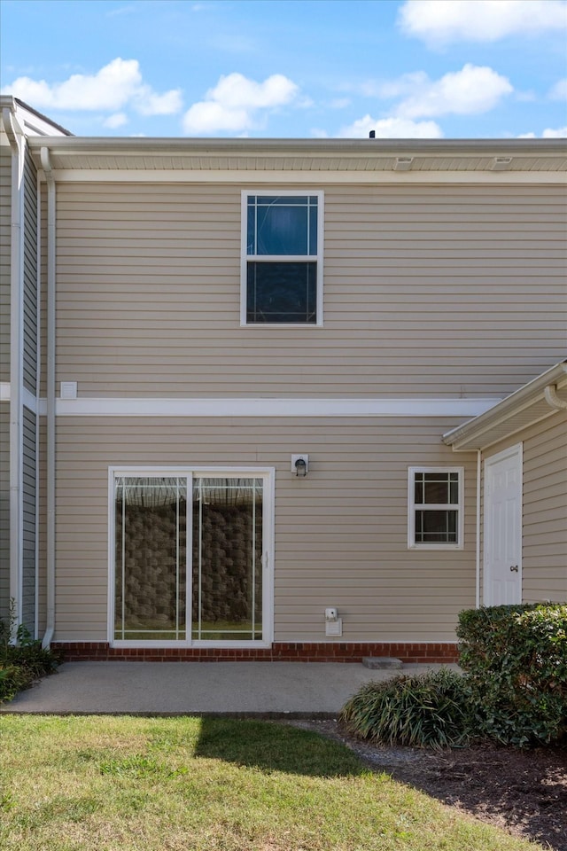 back of house featuring a lawn