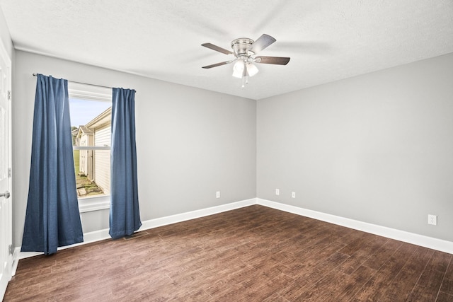 unfurnished room featuring a textured ceiling, ceiling fan, and dark wood-type flooring