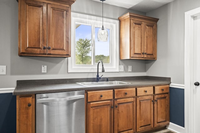 kitchen featuring dishwasher, sink, and hanging light fixtures