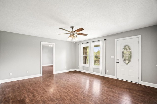 entrance foyer featuring a textured ceiling, dark hardwood / wood-style flooring, and ceiling fan