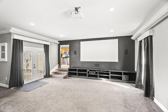 carpeted cinema room featuring french doors