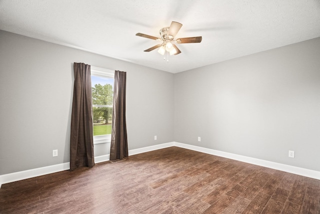 unfurnished room with ceiling fan, dark hardwood / wood-style flooring, and a textured ceiling