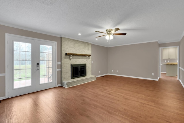 unfurnished living room with ceiling fan, crown molding, and french doors