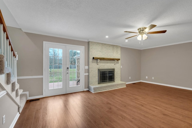 unfurnished living room featuring crown molding, ceiling fan, french doors, and wood-type flooring