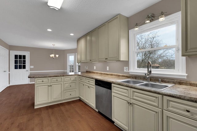 kitchen with kitchen peninsula, dishwasher, decorative light fixtures, and cream cabinetry