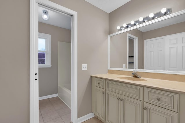 bathroom featuring vanity, tile patterned floors, and a tub