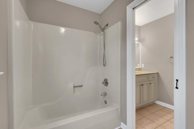 bathroom featuring tile patterned floors, vanity, a textured ceiling, and bathing tub / shower combination