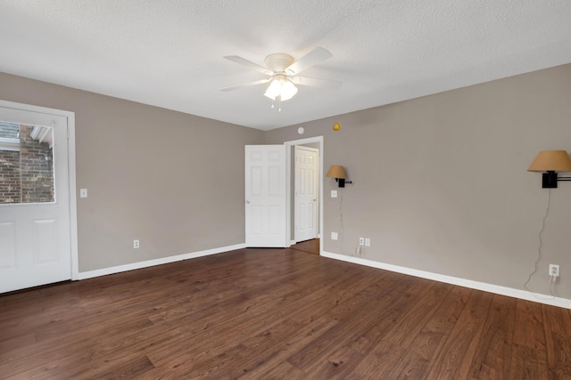 unfurnished room with a textured ceiling, ceiling fan, and dark wood-type flooring